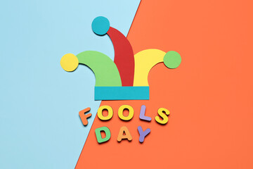 Test FOOLS DAY with paper clown hat on color background