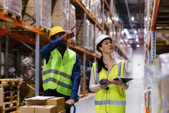 Multicultural duo warehouse workers distribution center