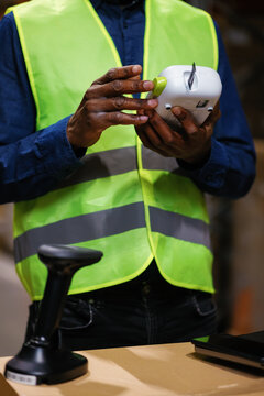 Anonymous black man grasping equipment