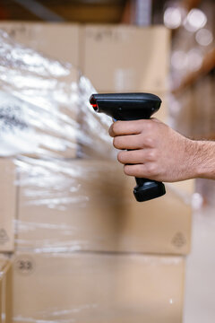 Unknown person grasping handheld scanner