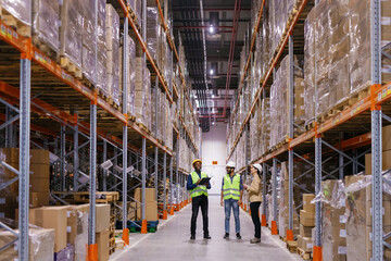 Helmeted workers conducting warehouse audit reflective gear