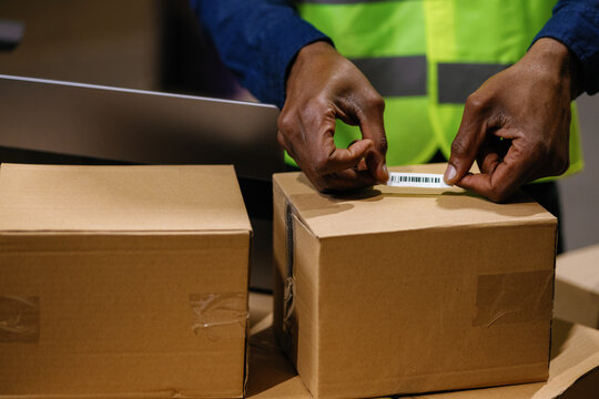 Box packaging anonymous barcode employee working