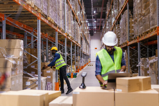 Warehouse workers packing cargo distribution center