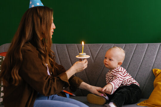 Baked good parenting make a wish blow out candle bday party childhood