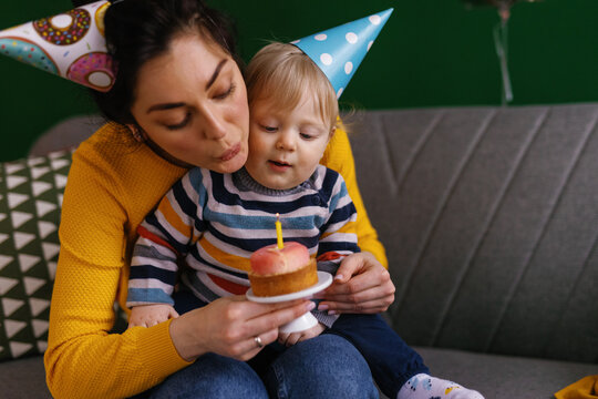 Parenting anniversary bday cupcake kid extinguish candle make a wish