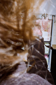 Anonymous girl taking money in a cash register machine