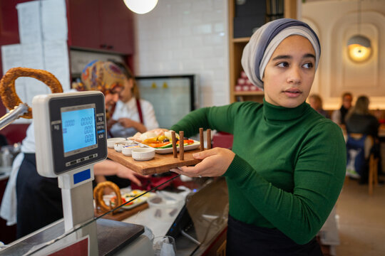 Muslim Waitress Serving Breakfast 