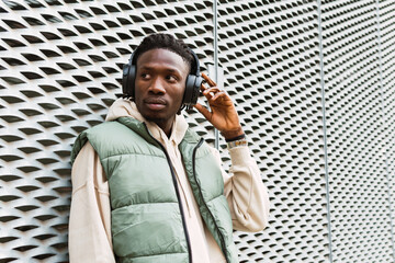Black man putting on headphones