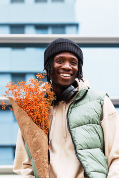 Cheerful black man with flowers