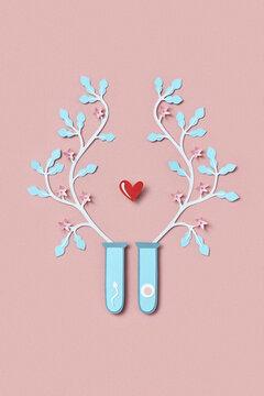 Colorful paper test tubes with ovum and spermatozoon inside