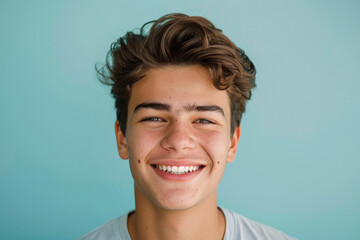 A young man with acne on his face smiles for the camera - obrazy, fototapety, plakaty