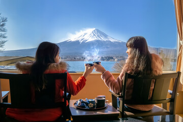 Japanese family relaxing in their room.Bedroom has a view of Mt Fuji.Fuji view outside the window.	
