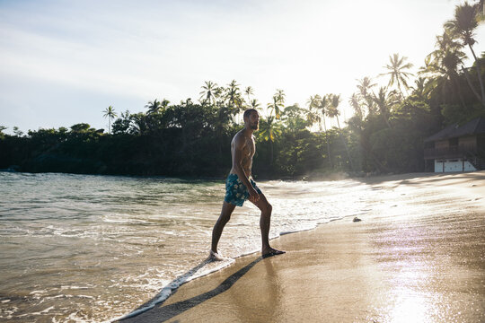 Young man bathing in the Caribbean Sea on an exotic beach