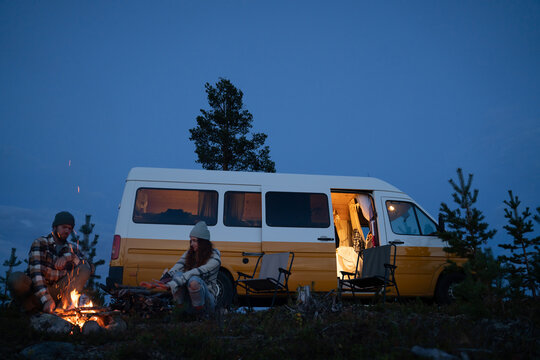 Couple bonfire by camper van