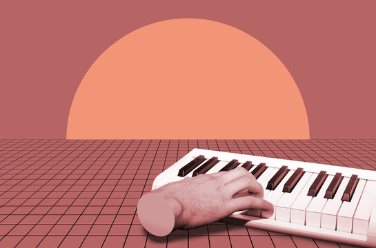 A hand of a man playing synthesizer 
