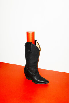 Black leather fashion style cowboy boot with hard direct flashlight
