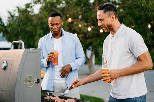 Two men barbecue