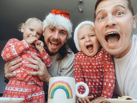 UGC Selfie Of A LGBT happy family with kids at christmas time. 
