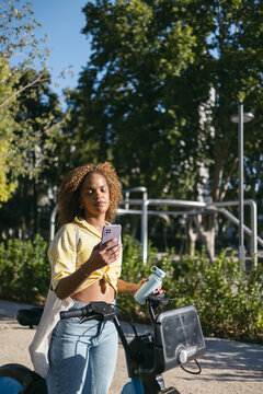 Woman checking the map while using electric bike in the city