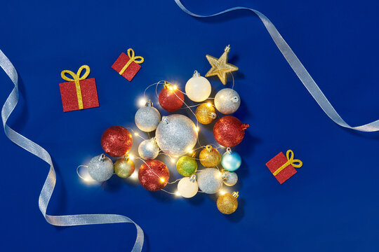 Cute Christmas tree shape made of small ornaments and greenery