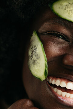 Woman with cucumber slices on her face