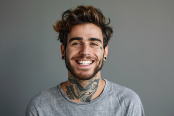 A man with a tattoo on his neck is smiling