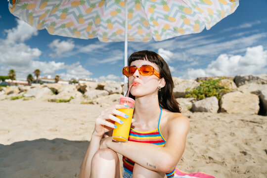 Drinking Cold-pressed juice at the beach