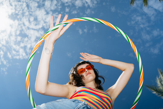 Woman posing with hula hoop