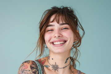 A woman with tattoos and a nose ring is smiling
