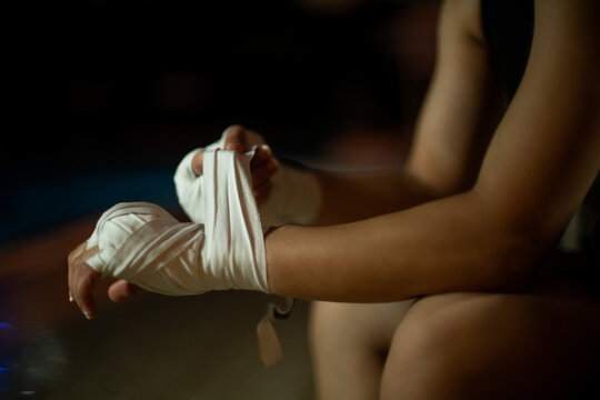 Woman Wrapping Hand Wrap before Boxing