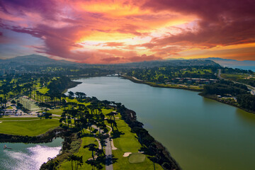 aerial shot of a beautiful spring landscape at Lake Merced with blue lake water and lush green...