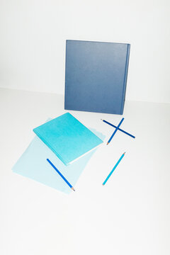 Monochromatic blue office supply on desk with hard direct flashlight