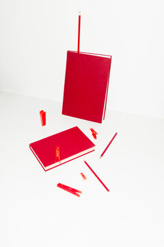 Monochromatic red office supply on desk with hard direct flashlight