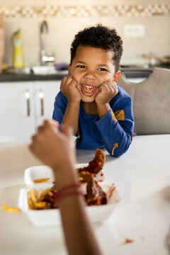 Toddler eating chiken wings