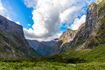 unique stunning landscape of Milford Sound - fjord and tall waterfalls flowing down the wall of a mighty mountain in Fiordland National Park, Southland, New Zealand