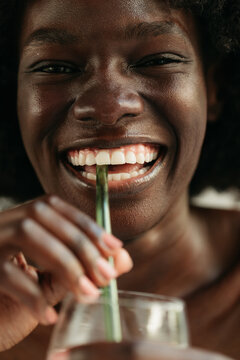 Portrait of Young African-American Woman drinking with straw
