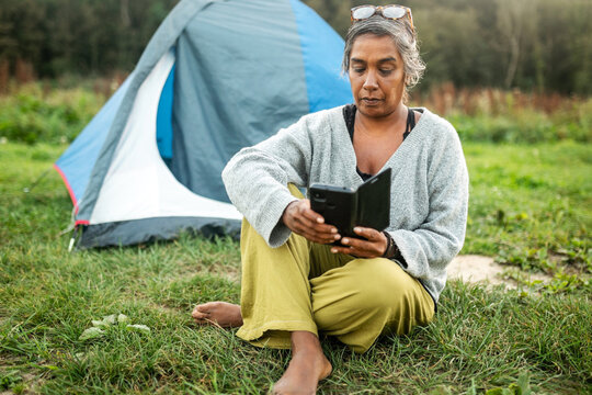 middle aged indian woman camping in nature
