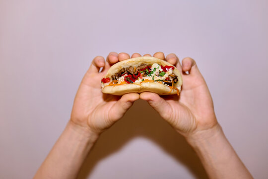 Anonymous hands holding bao bun