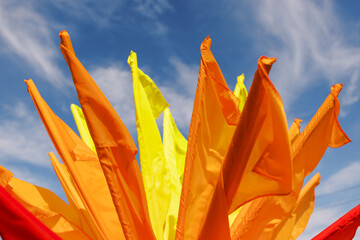 red and yellow flags on the blue sky background