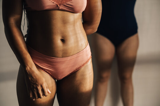 image of the torso of two women dressed in underwear.
