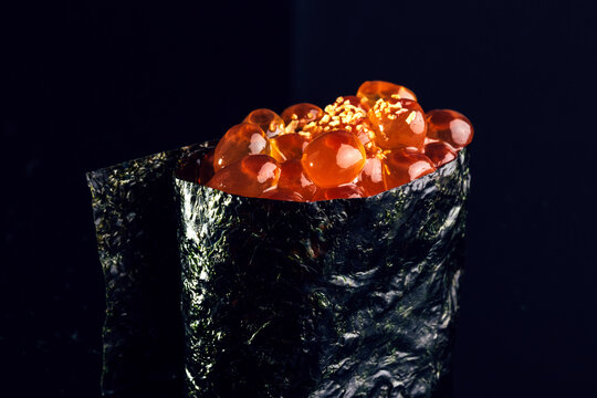 Appetizing gunkan maki against black background