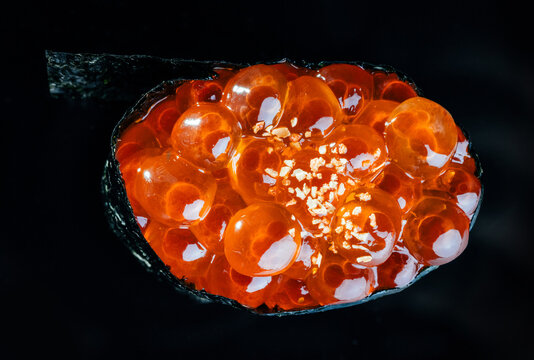 Appetizing gunkan maki against black background