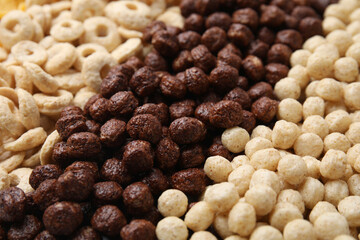 Different types of breakfast cereals as background, closeup