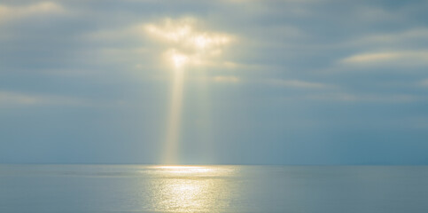 panorama of the sea with the sun's rays breaking through the clouds in Ericeira. divine heavenly...