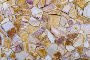 A wall made of stone with a pattern of brown and white stones
