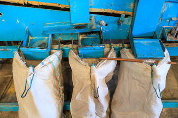 A blue machine with bags hanging from it
