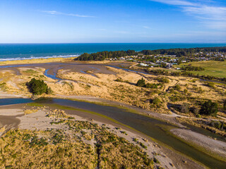 aerial panorama of ashley river mouth and waikuku beach in canterbury, south island, new zealand; sunset over unique ecosystem near christchurch