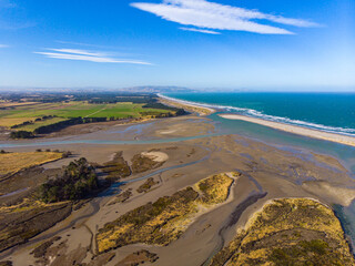 aerial panorama of ashley river mouth and waikuku beach in canterbury, south island, new zealand; sunset over unique ecosystem near christchurch