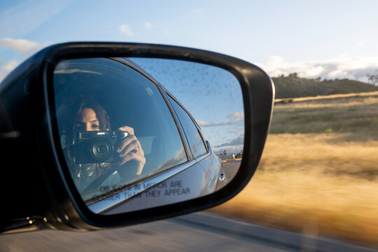 Woman Taking Photos In The Rear View Mirror