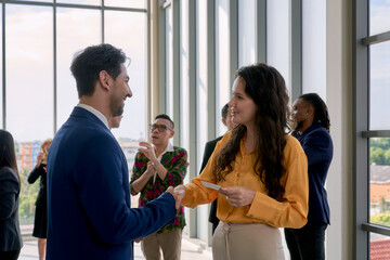 Businessman and woman shake hand together in seminar room for communicate and discuss for a...